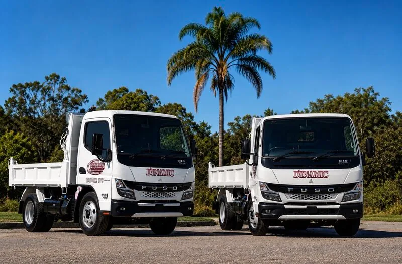 Fuso tip trucks in Dynamic livery lined up in the fleet yard